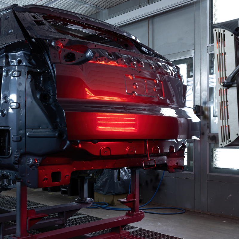 Car being painted in professional spray booth